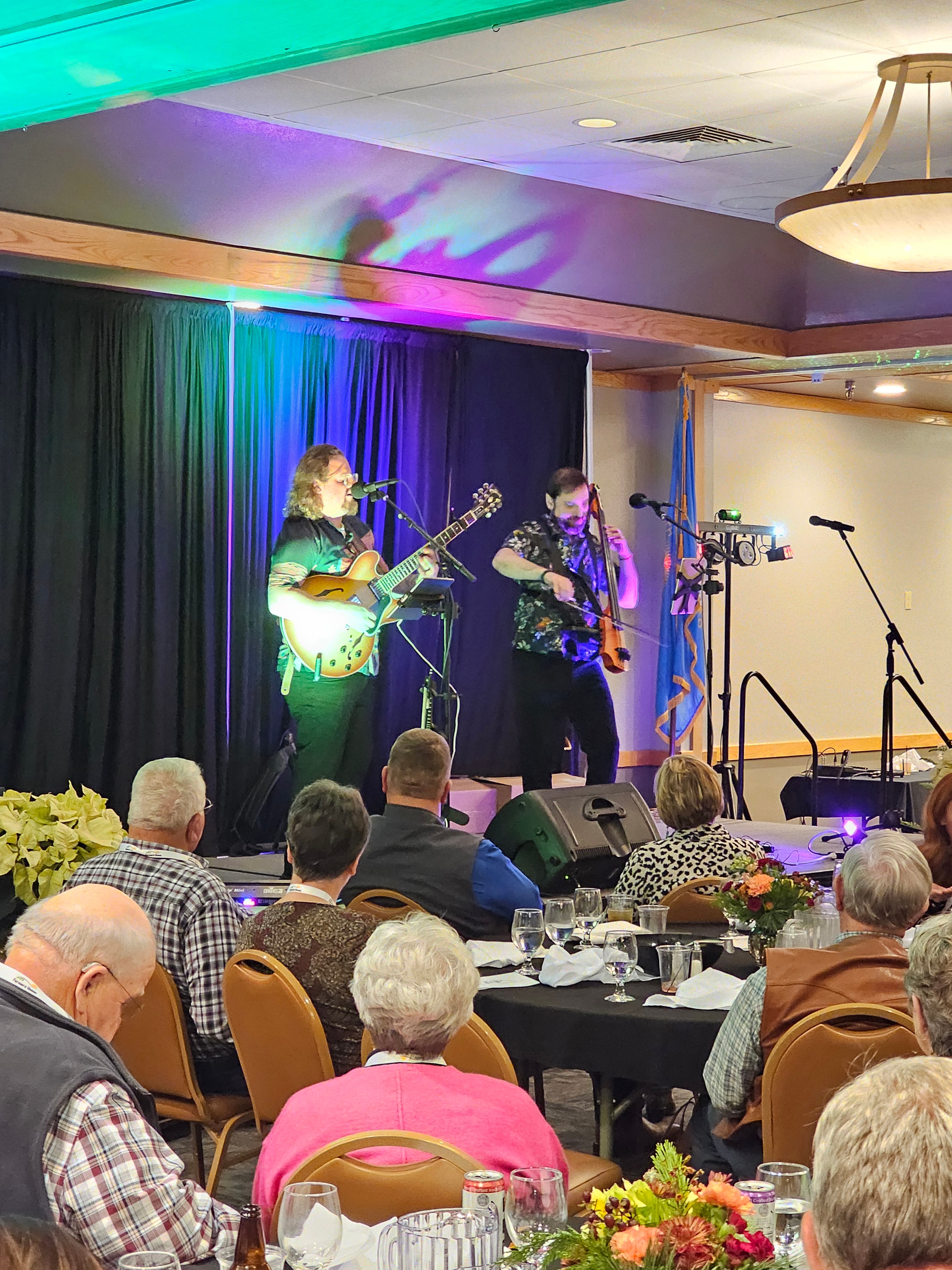 Band performing on stage with guitar and violin