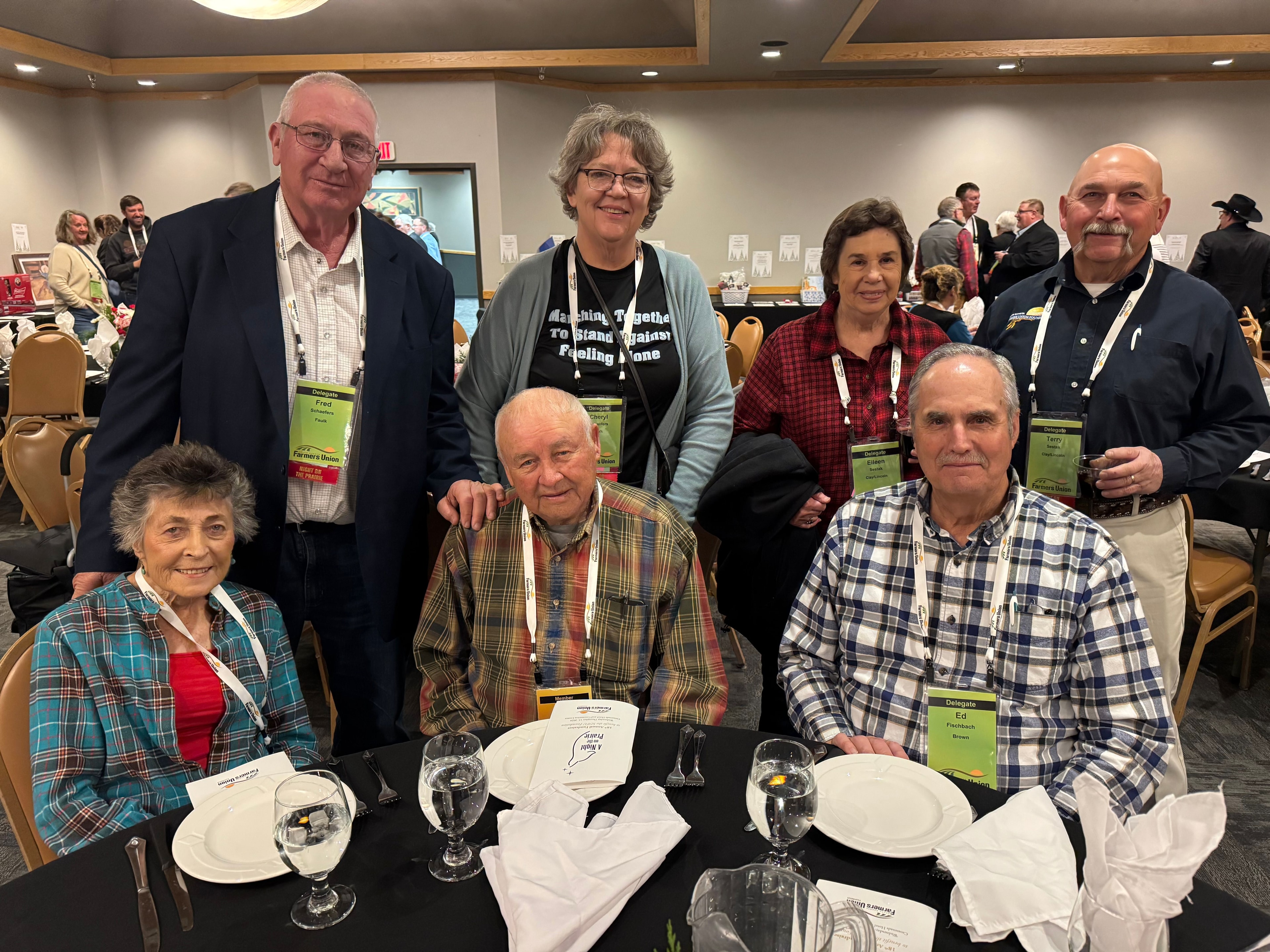 Group of seven attendees gathered at a table