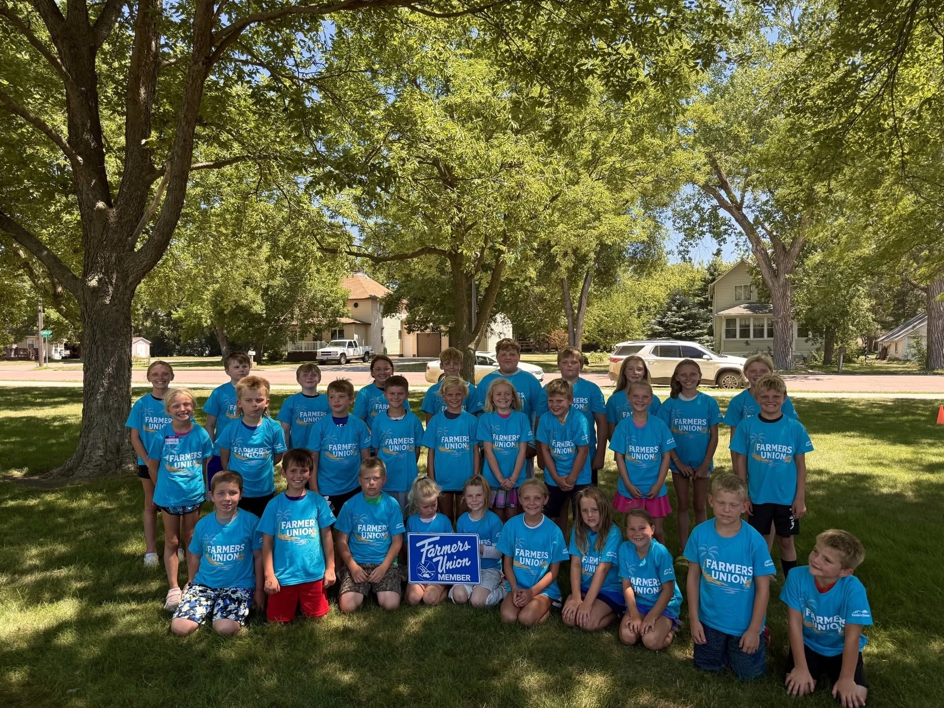 Large group of children in Farmers Union t-shirts at youth camp